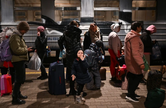 omen and children arrive at Przemysl train station