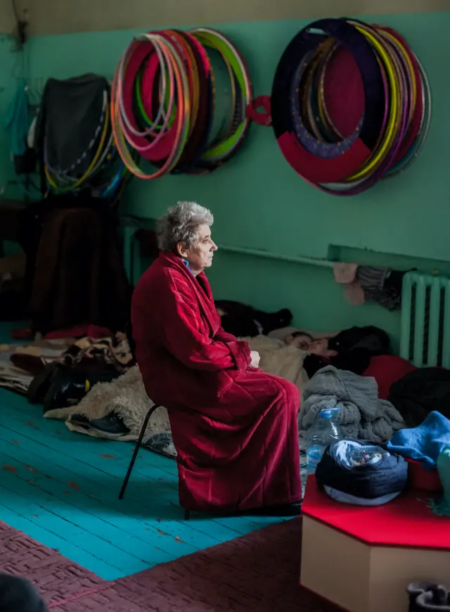 A woman in a bomb shelter in Mariupol