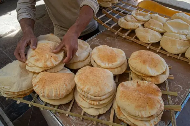 Egyptian men work in a bakery at a market in Cairo