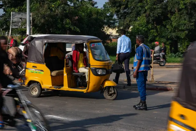 Traffic policeman stops a tuk-tuk in Bujumbura