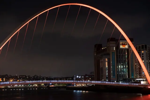 Gateshead's Millennium Bridge illuminated orange