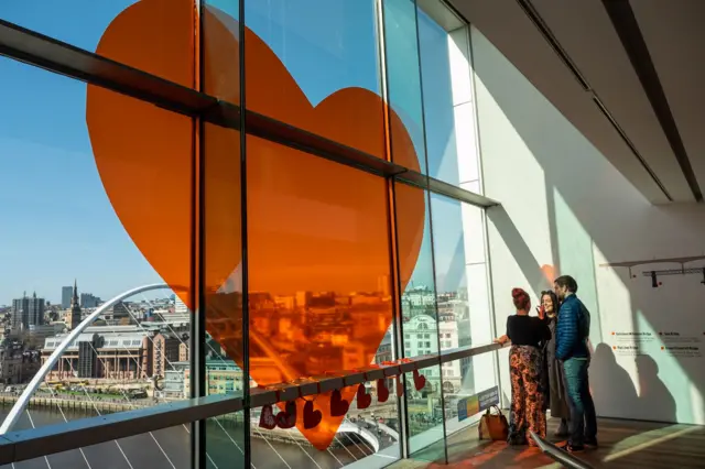 Orange heart from Together With Refugees in the viewing platform window at Baltic, Gateshead