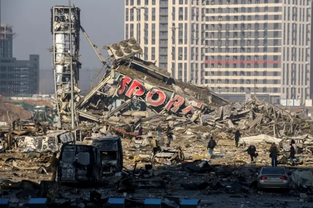 The site of a destroyed shopping center is seen after it was hit in a military strike in the Podilskyi district of Kyiv