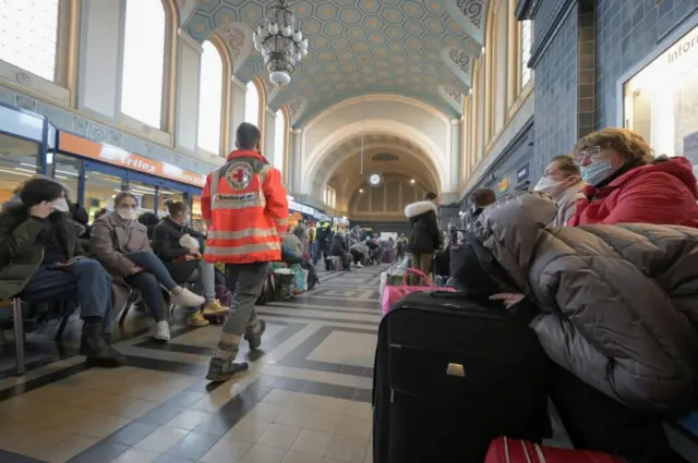 Refugees fleeing Russia's invasion of Ukraine wait in the station hall, on their way to Leipzig, at the central station in Goerlitz, Germany