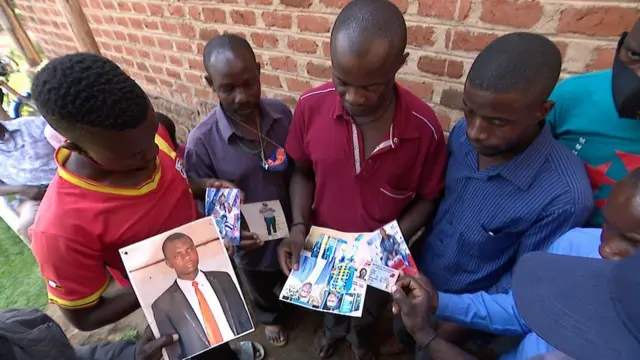 Villagers from Kisamula in Uganda with photos of relatives who disappeared - 2021