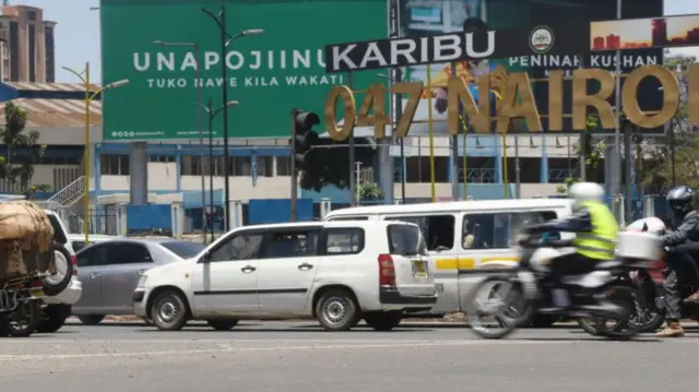 A Kenyan road with cars on it