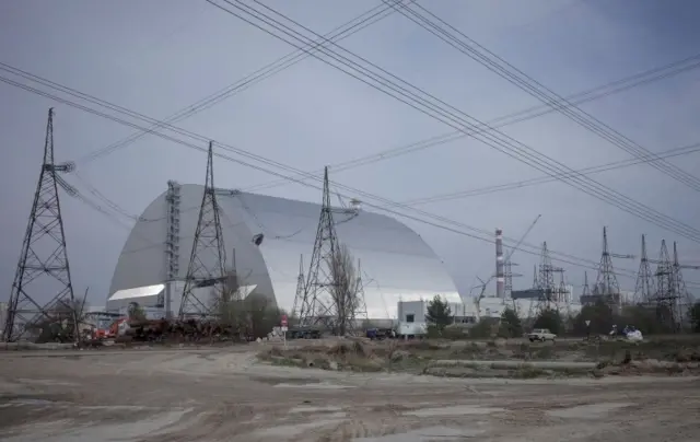 A general view shows a New Safe Confinement structure over the old sarcophagus covering the damaged fourth reactor at the Chernobyl nuclear power plant, Chernobyl 11 March 2022