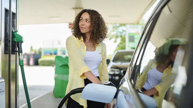 Woman filling up a car