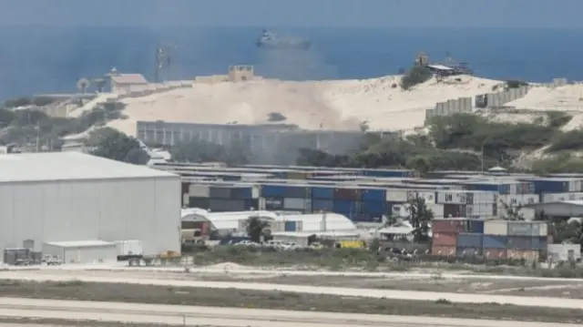 A general view shows smoke billowing from shipping containers near the Adan Abdulle International Airport international in Mogadishu, Somalia - 23 March 2022