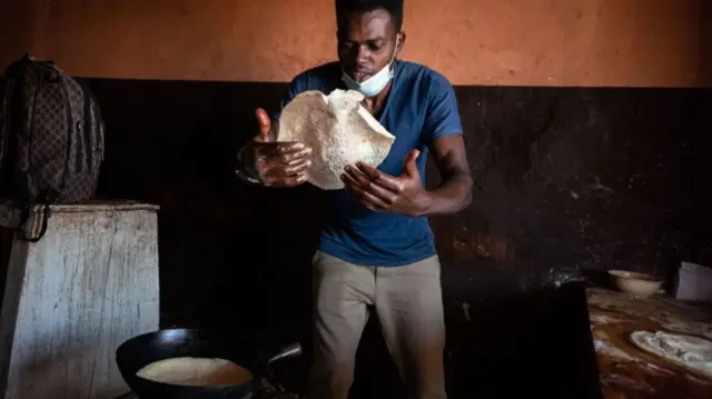 Abdullatifu Nyinsenga makes chapatis for his restaurant in Kigali, Rwanda, on 23 March 2022