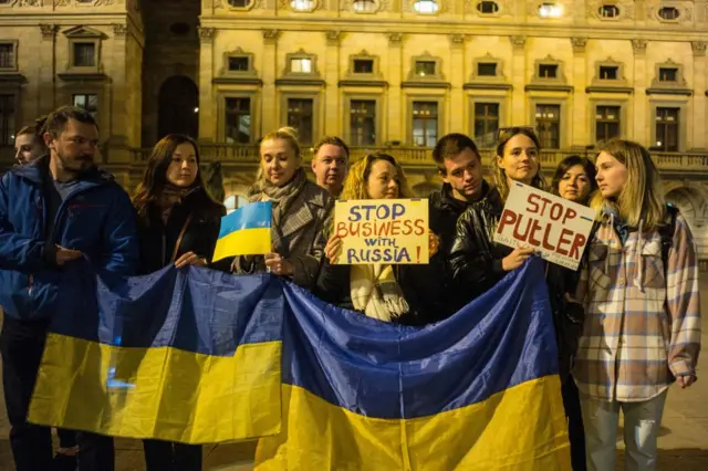 Demonstrators hold placards and Ukrainian flags during a rally against Russia's invasion of Ukraine on March 22, 2022 in Prague, Czech Republic.