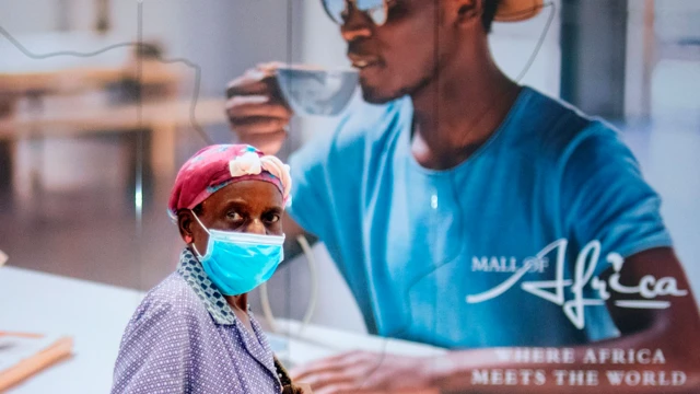 A woman wears a face mask at the Africa Mall in Johannesburg in South Africa - archive shot