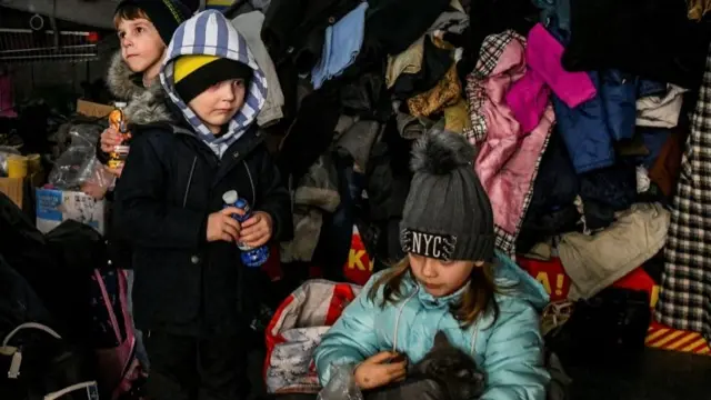 Children rest at a collecting point after fleeing from Mariupol to Zaporizhzhia, 22 March 2022