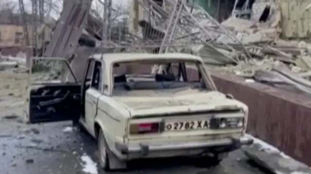 A damaged vehicle is seen outside a destroyed hospital building, amid Russia's ongoing invasion of Ukraine, in Izyum, Ukraine, on 8 March 2022