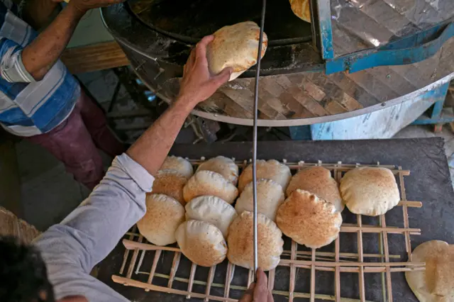 Egyptian men work in a bakery at a market in Cairo, on March 17, 2022