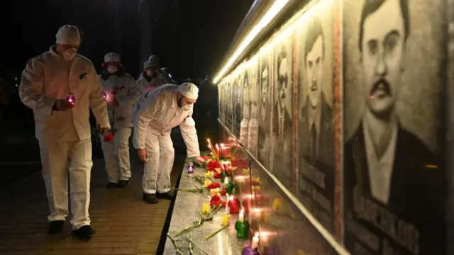 Chernobyl employees seen laying flowers last April at the Slavutych city memorial to the victims of the 1986 meltdown