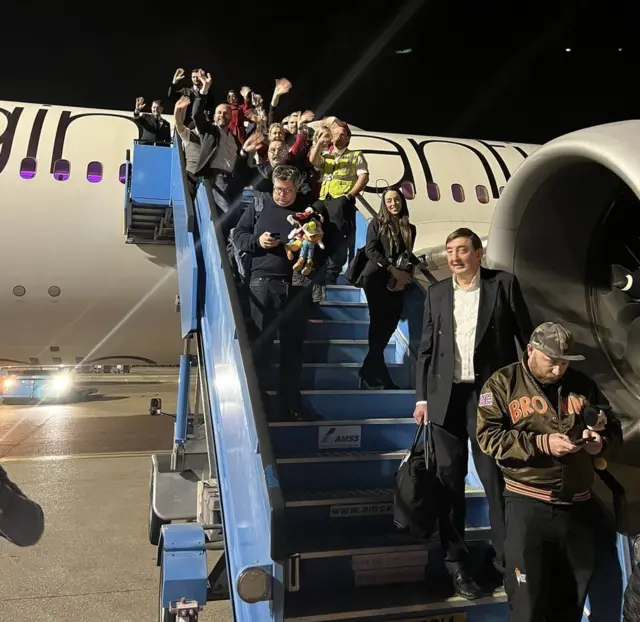 Ukranian children getting off plane