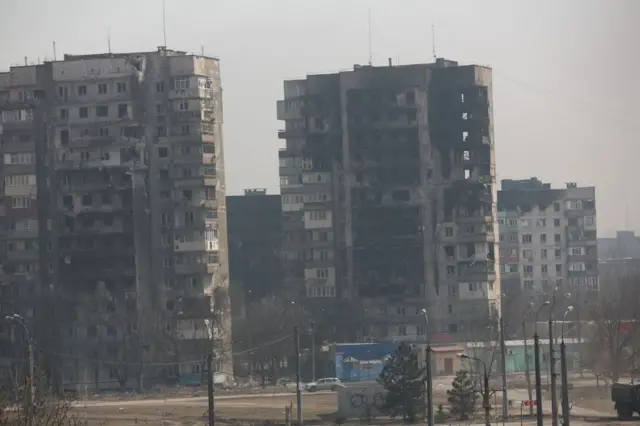 Damaged buildings are seen on the Mariupol skyline