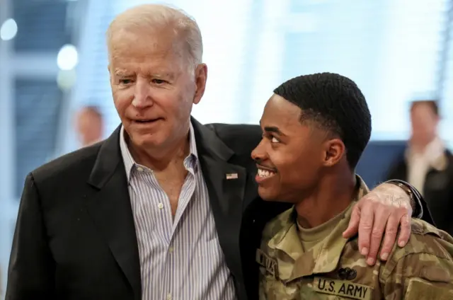 U.S. President Joe Biden speaks with a soldier