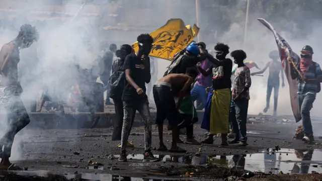 People take part in demonstrations held near the presidential palace demanding the civilian rule and the release of political prisoners