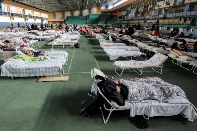 Ukrainian refugees who fled the war in their country take shelter in the main hall of an athletics complex in Moldova's capital Chisinau