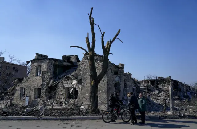 Destroyed buildings are seen in Mariupol as civilians are evacuated along humanitarian corridors