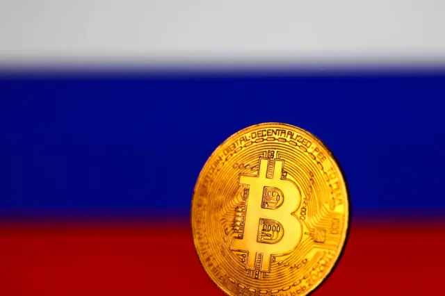 Bitcoin set against the Russian flag.