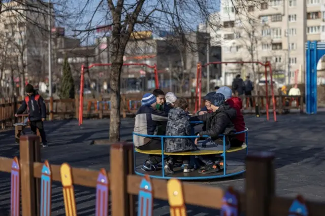 Kids play in a park, as Russia"s invasion of Ukraine continues, in Kyiv, Ukraine March 25, 2022.