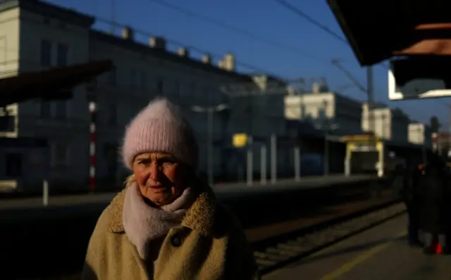 A Ukrainian refugee waits to board a train bound for Krakow on the platform of Przemysl Glowny train station, after fleeing the Russian invasion of Ukraine, Poland, March 24