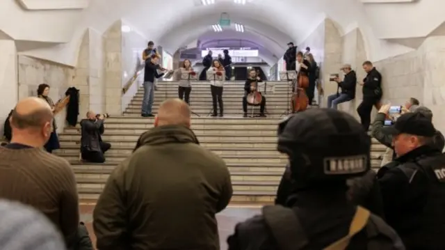 People listen to classical music performed by local musicians in a metro station that serves as a bomb shelter in Kharkiv, as Russia"s attack on Ukraine continues, Ukraine, March 26, 2022