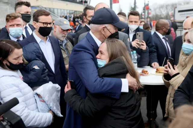 US President Joe Biden hugs a Ukrainian woman in Warsaw