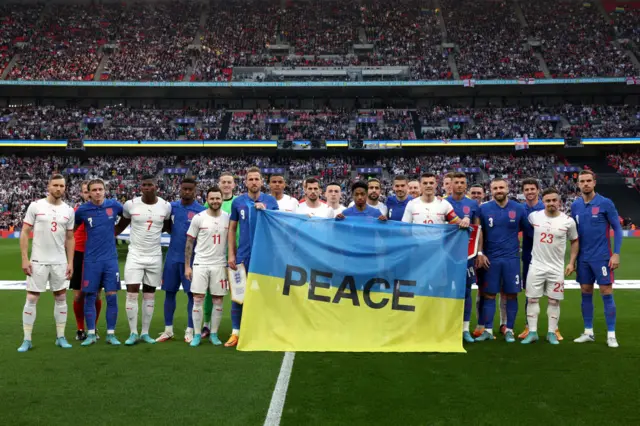 England and Switzerland pose with 'peace' message for Ukraine