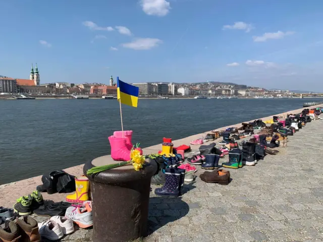 300 pairs of worn shoes have been placed along the banks of the Daube river in Budapest to commemorate the victims of the Mariupol theatre bombing in Ukraine