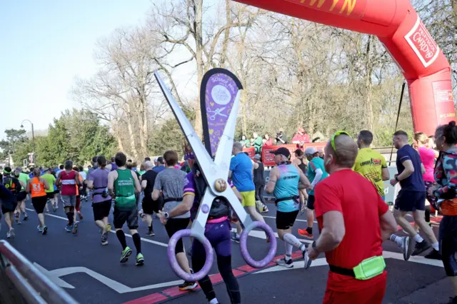 runner in a scissors costume