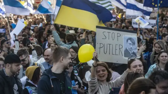 Members of Prague's Russian community holding placards take part in an anti-war demonstration in Prague,