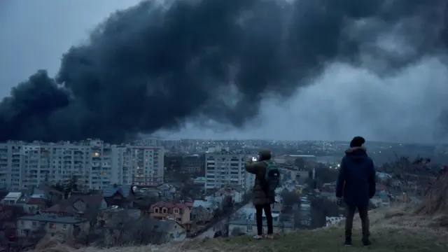 People watch as smoke rises above Lviv after a Russian airstrike