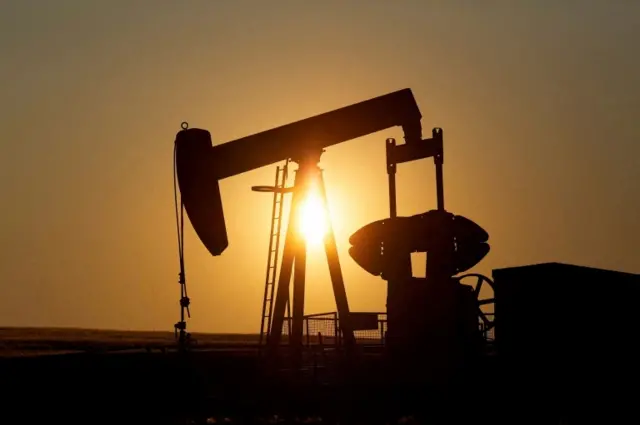 An oil pump jack pumps oil in a field near Calgary, Alberta, Canada