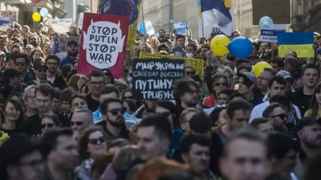 Members of Prague's Russian community holding placards take part in an anti-war demonstration in Prague,