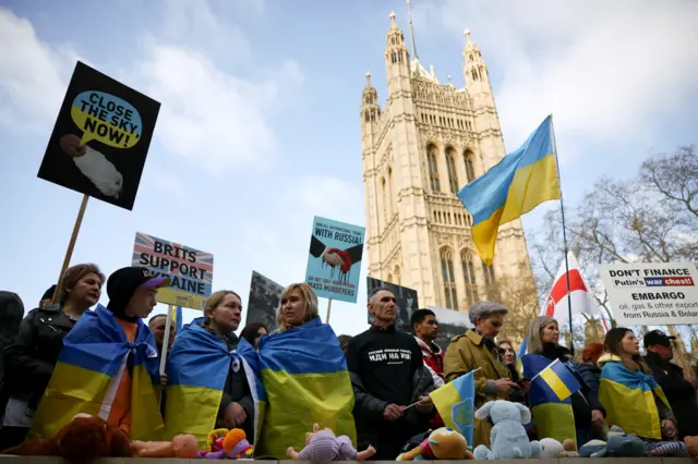 Demonstrators with Ukrainian flags gather outside London's Houses of Parliament