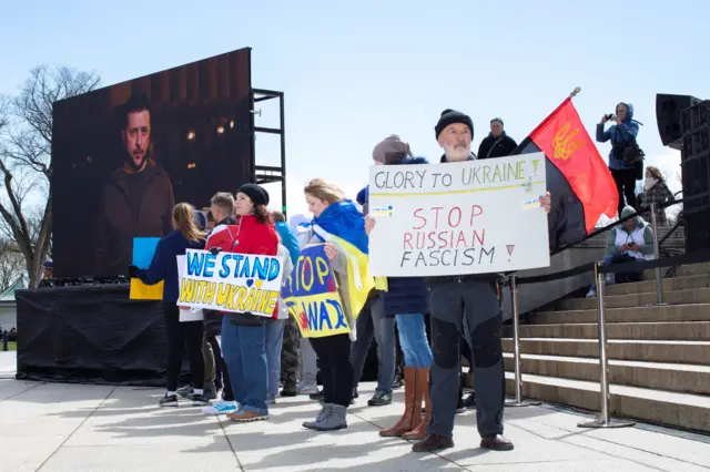 Demonstrators hold signs in support of Ukraine at the National Mall in Washington