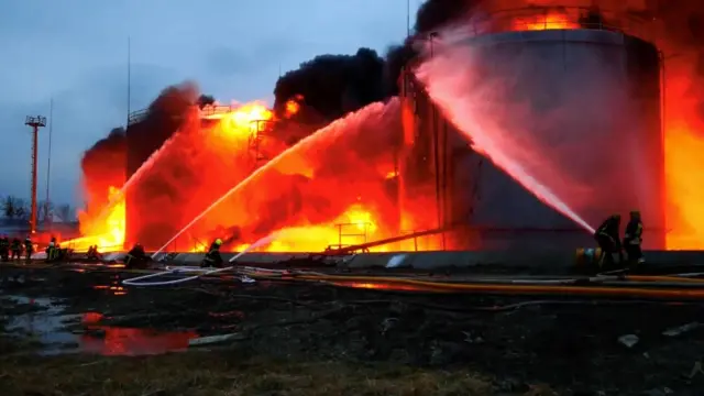 Firefighters tackle the blaze at the fuel storage facility in Lviv after a missile strike