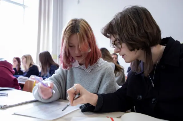 Ukraine teens work on a task in a classroom