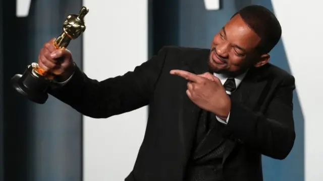 Smith struck several poses with his award as other stars queued to have their photographs taken