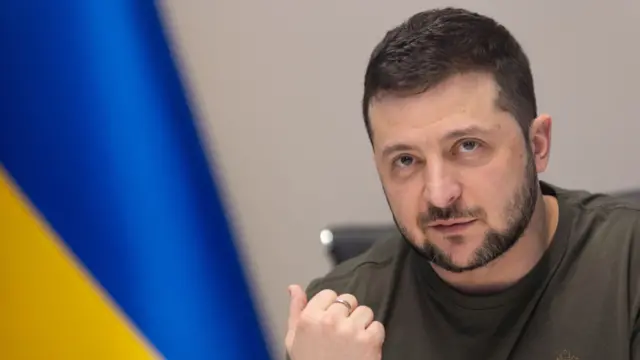 Ukrainian President Volodymyr Zelensky in front of Ukraine's flag