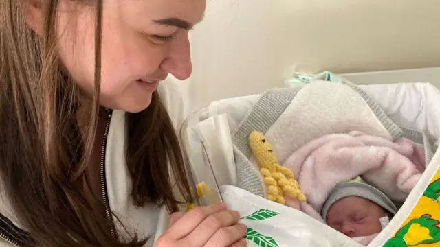 Iryna Zelena pictured with one of her twin daughters