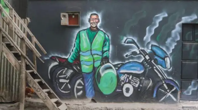 A mural showing a motorbike taxi rider