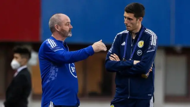 Scotland head coach Steve Clarke in conversation with Ross Stewart, who is not included among the substitutes