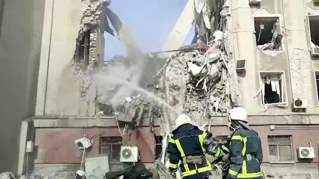 Firefighters putting out a fire in a building in Mykolaiv