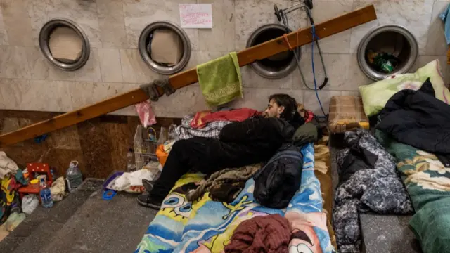 A man sleeps as he shelters in a subway station on March 28, 2022 in Kharkiv, Ukraine.