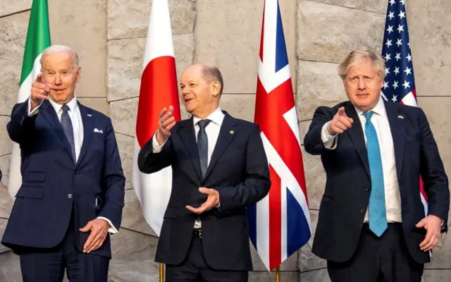 U.S. President Joe Biden, German Chancellor Olaf Scholz and Britain"s Prime Minister Boris Johnson pose for a family photo during the G7 summit in Brussels, Belgium, March 24, 2022